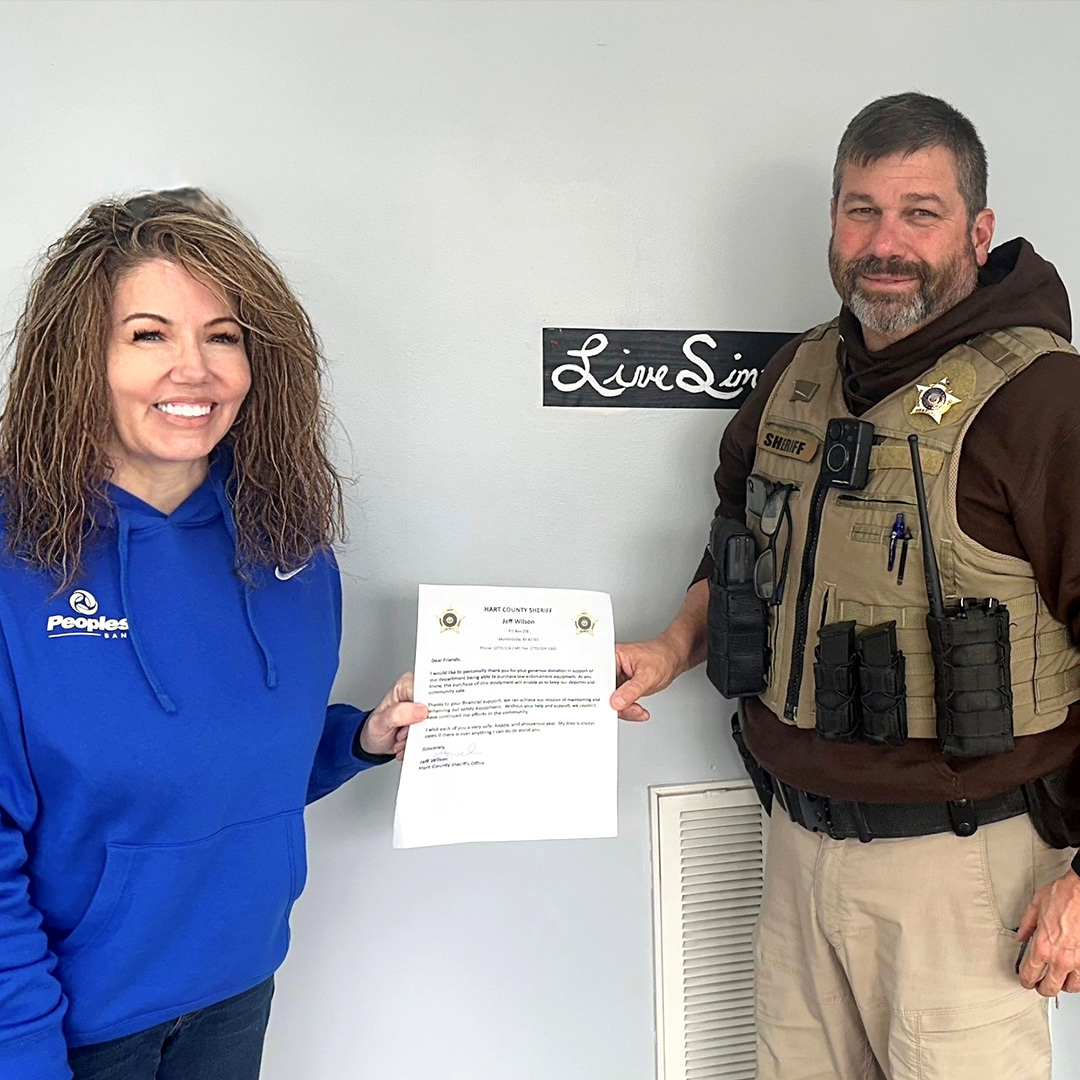 Munfordville Branch Manager Jacquelyn Crain presents a letter of donation to Hart County Deputy Sheriff Tim Nichols